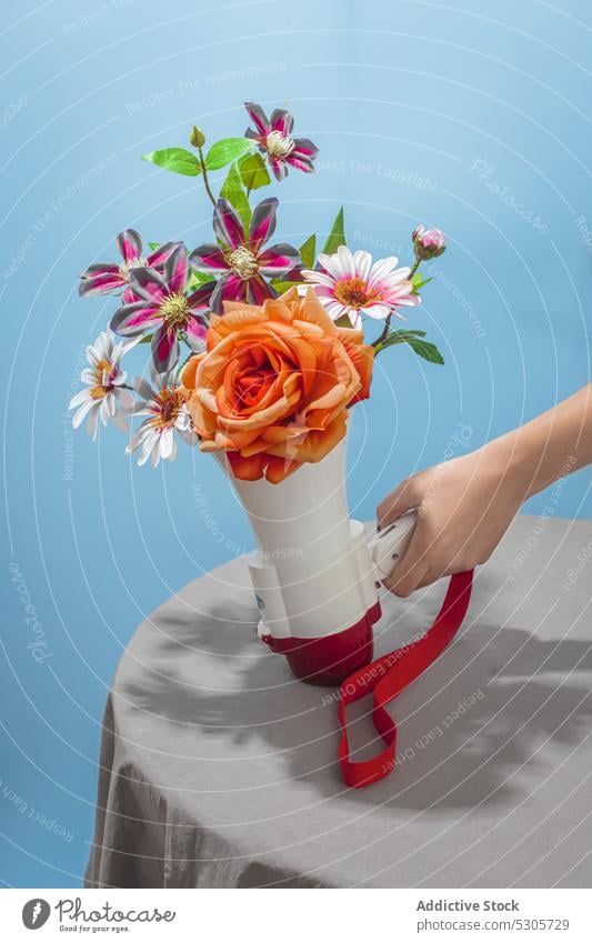 Woman with bouquet of flowers in megaphone woman voice speaker bunch bloom colorful table female loudspeaker amplifier loud hailer advertise marketing promotion