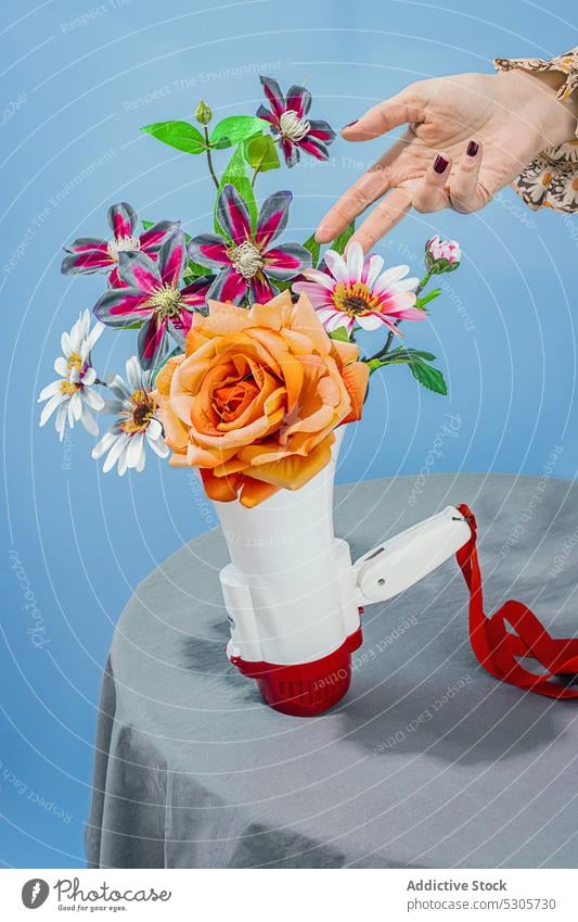 Woman with bouquet of flowers in megaphone woman voice speaker bunch bloom colorful table female loudspeaker amplifier loud hailer advertise marketing promotion