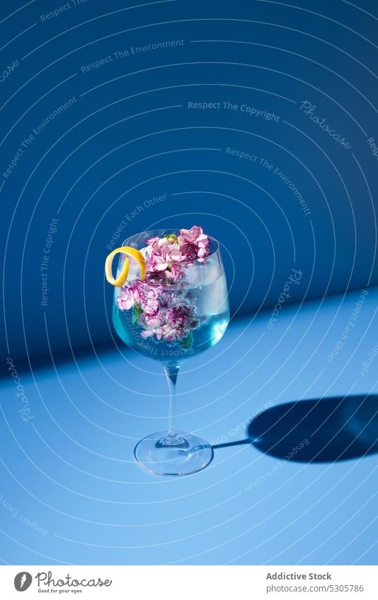 Glass of cocktail with flowers glass fresh mint drink leaf alcohol transparent composition beverage refreshment bright bloom liquid aroma natural colorful