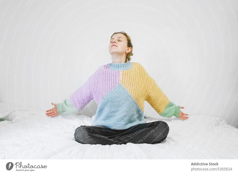 Calm woman meditating on bed meditate lotus pose yoga zen home practice mindfulness calm female eyes closed relax peaceful padmasana spirit tranquil serene