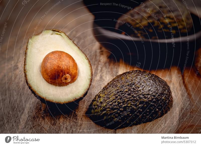 Avocado halfs on a wooden board, selective focus avocado avocados fresh healthy nutrition food delicious natural ingredient organic diet ripe vegetarian