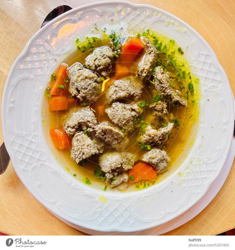 Soup in the plate from above - the liver dumpling is already cut up Café society liver dumplings liver dumpling soup beef broth Root vegetable Hot hot soup