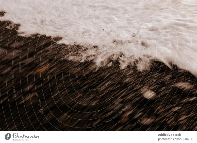 Foamy sea waving on sandy beach wave shore stone foam wet water coast environment lanzarote nature splash spain canary islands seashore seaside coastline scenic