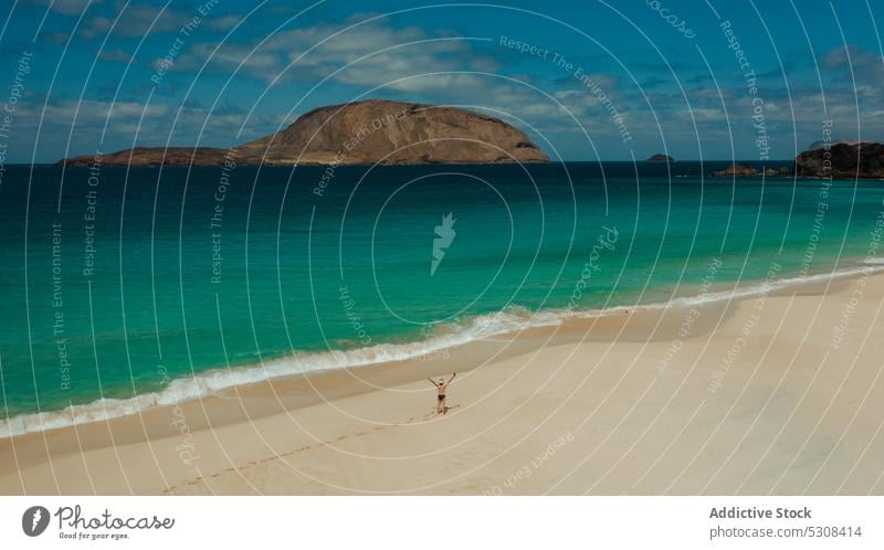 Silhouette of tourist standing on sandy seashore beach traveler landscape vacation coast summer freedom lanzarote canary islands spain wave ocean water seaside