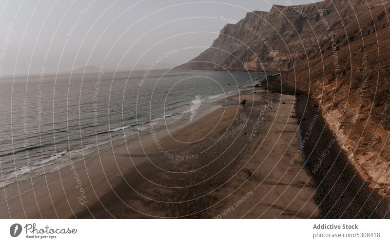 Sandy beach with rocky formations and sea sunset wave landscape coast nature ocean seascape shore spain lanzarote canary island sundown seashore picturesque