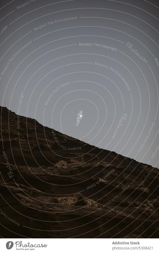 Rocky mountain slope under cloudless evening sky range landscape nature ridge highland valley moon rocky scenery formation peaceful rough environment lanzarote