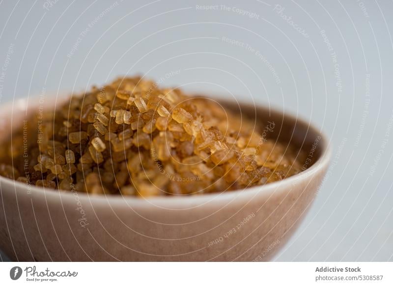 Brown textured sugar in the bowl brown candied cane caramel cook cooking crystal crystallized demerara eat eating food glucose ingredient kitchen meal