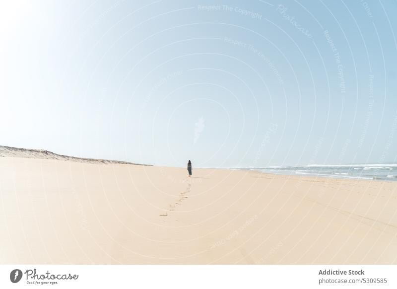 Distant traveler walking on wet sandy beach woman sea summer wave seashore coast nature trip ocean vieux boucau les bains france person water vacation seaside