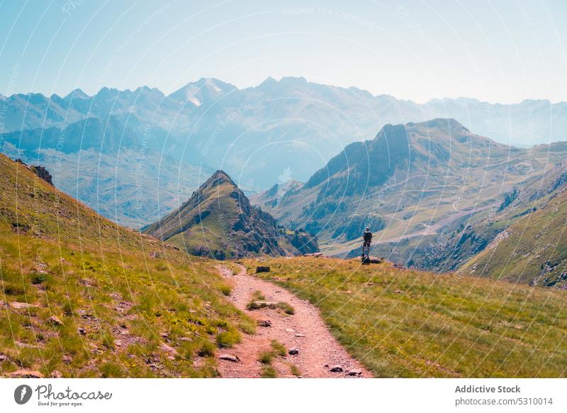 Traveler walking on path in mountains fog traveler slope tourist landscape nature explore grass anayet pyrenees huesca spain highland tourism environment hill