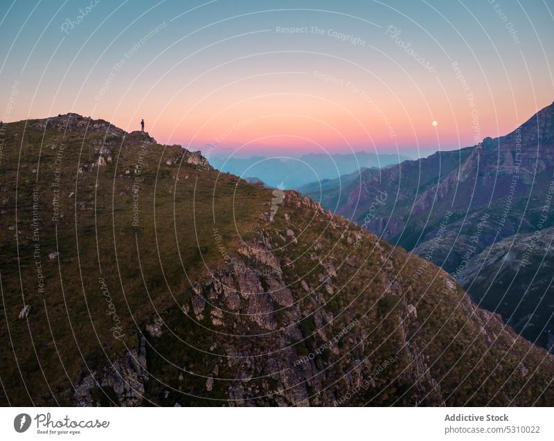 Silhouette of person admiring mountainous valley sunset admire traveler highland nature landscape sky silhouette ridge anayet pyrenees huesca spain scenic rocky