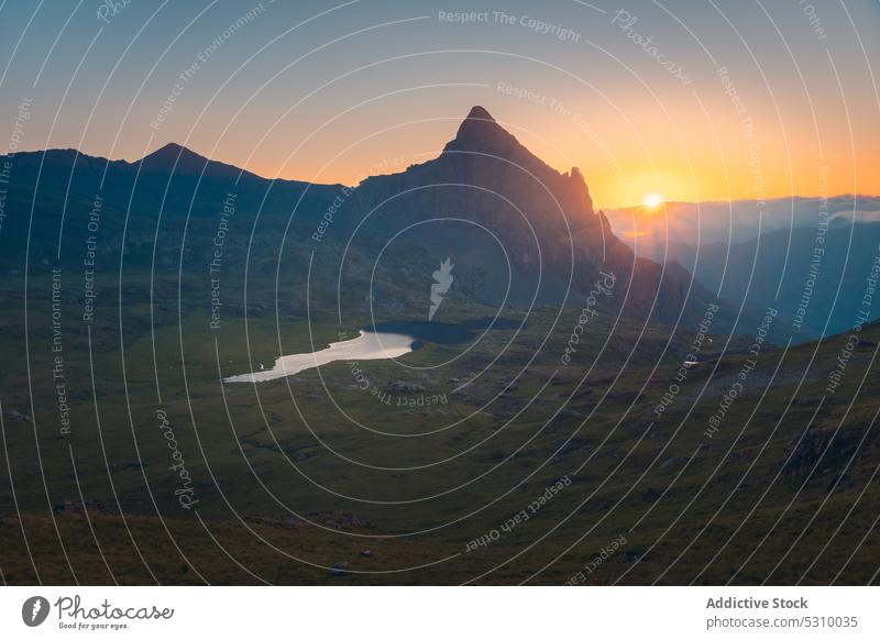 Rocky mountains and lake in evening sunset range pond highland landscape grass nature ridge water moss scenery anayet pyrenees huesca spain grassy clear rocky