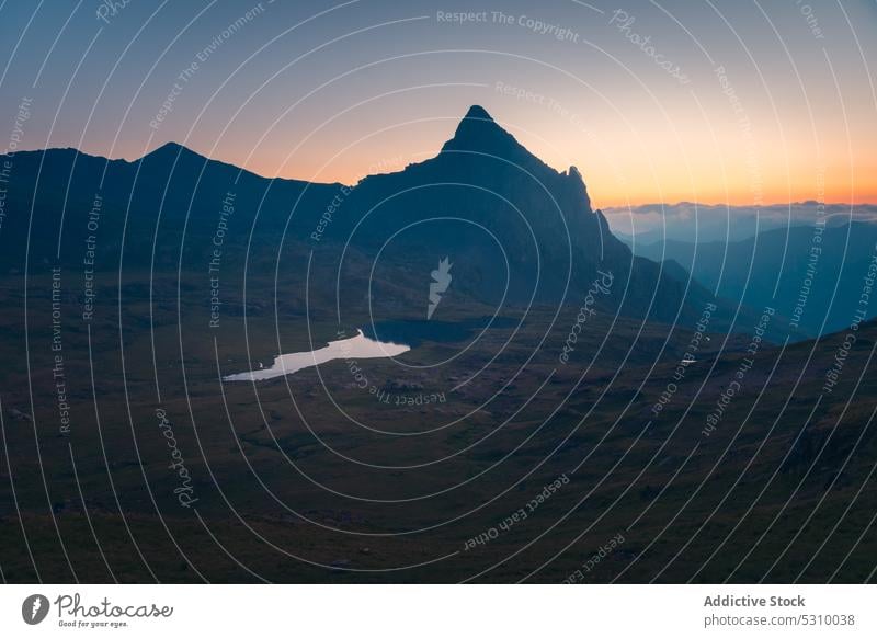 Rocky mountains and lake in evening sunset range pond highland landscape grass nature ridge water moss scenery anayet pyrenees huesca spain grassy clear rocky