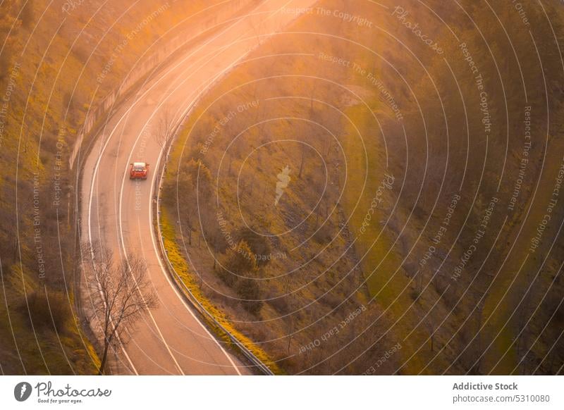 Car moving on mountain highway car road drive tree bush nature countryside transport landscape route trip travel scenic green asphalt plant path shrub journey