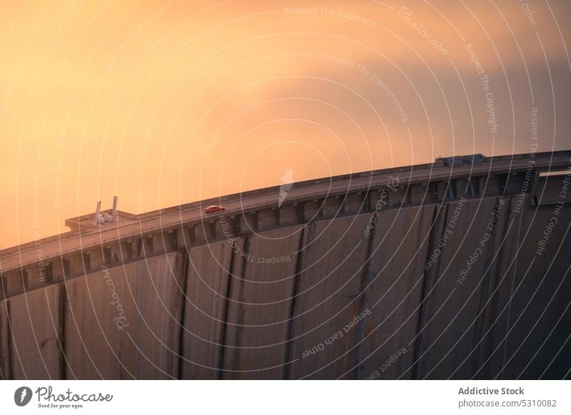 Drone view of car on bridge at sunset in Spain drive evening road building ride spain madrid modern fence transport sundown travel dusk journey architecture