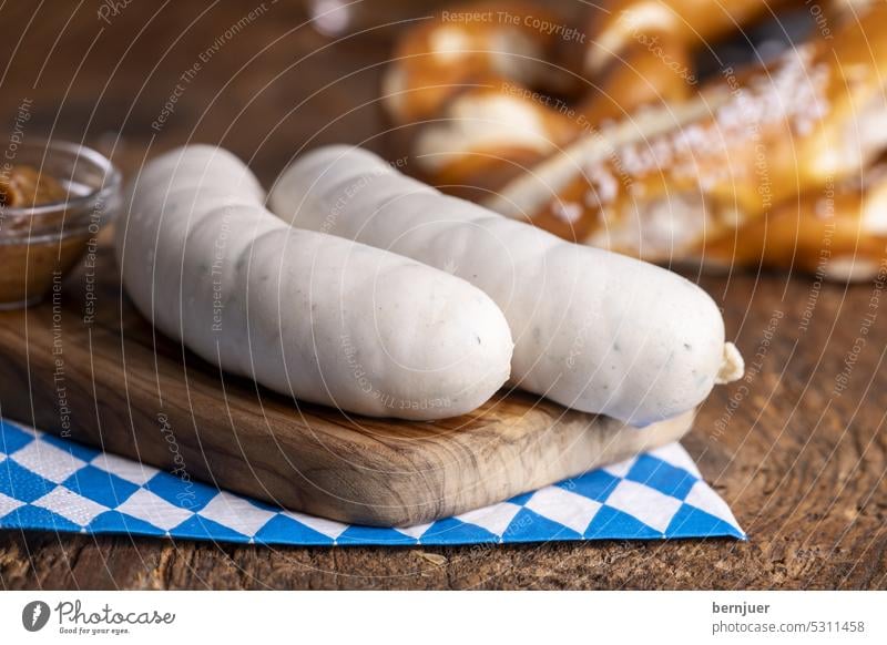 Two Bavarian white sausages on wood Veal sausage Mustard Beer Close-up Rustic Eating Tradition Beverage Oktoberfest traditionally Munich festival German Fresh