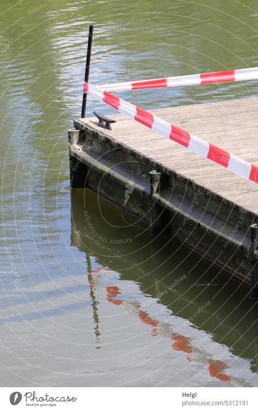 !Trash! 2023 | Barrier at the jetty with reflection investor cordon barrier tape Water peril Backup Safety Protection Reddish white flutterband Exterior shot