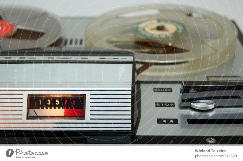 A vintage reel-to-reel tape recorder with a vu meter and a large switch from the seventies Technology energy old closeup detail silver antique old-fashioned