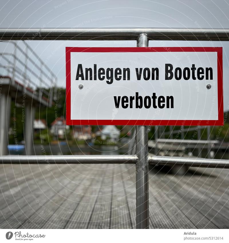 "Mooring of boats prohibited" | sign on the railing of a jetty at the bathing lake Prohibition sign interdiction Footbridge Swimming lake Jumping tower Clue