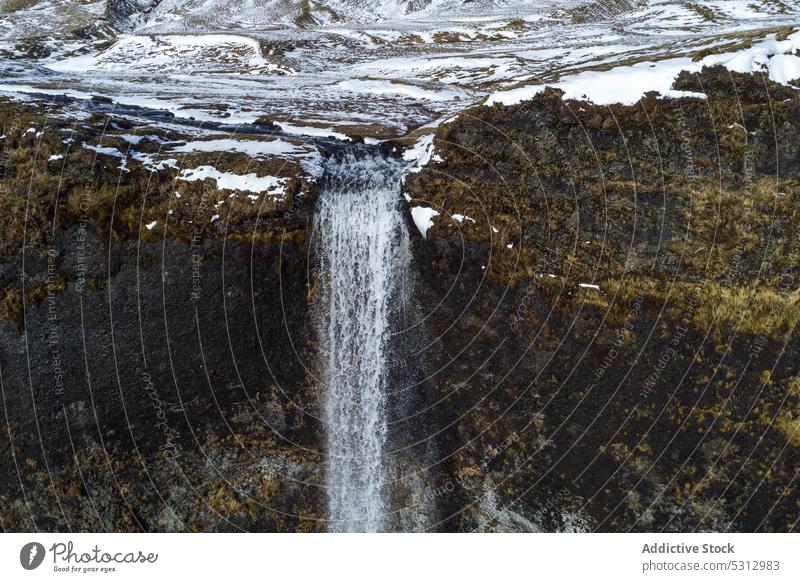 Cliff with clean waterfall in Iceland iceland cliff rock river mountain stream breathtaking rough formation national park stone flow cascade landscape nature