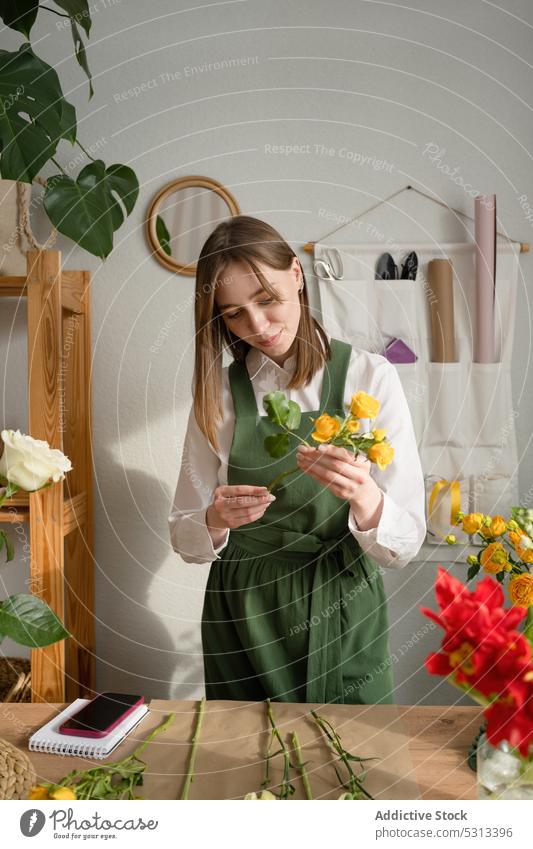 Woman working in florist shop woman flower bouquet arrange floristry store floral professional female job occupation plant fresh apron bloom small business