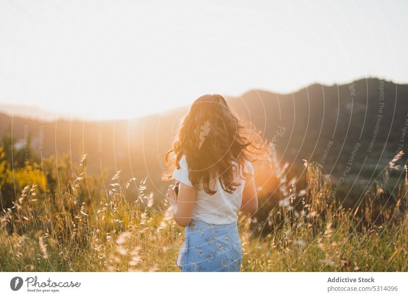 Anonymous woman with photo camera in sunny field photographer summer nature happy trip vacation countryside barcelona young spain travel female joy tourism