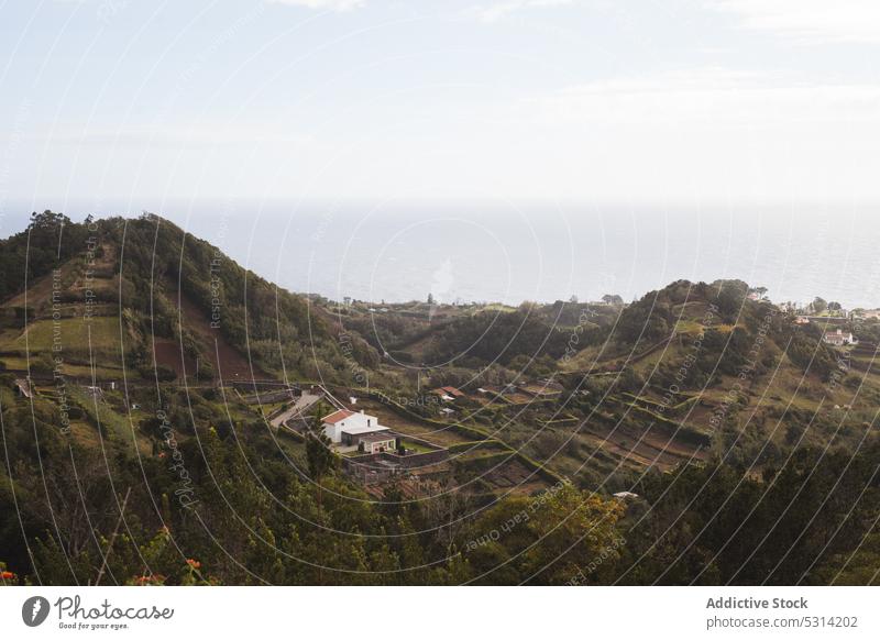 Picturesque view of mountains and trees with rural settlement in valley village hill countryside green landscape picturesque azores nature town scenery idyllic