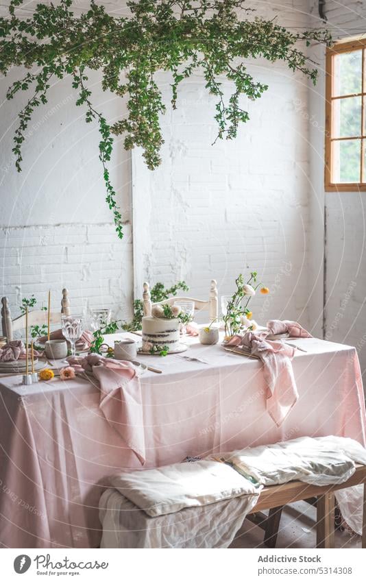 Banquet table with assorted dishware and delicious cake dessert elegant flower serve tablecloth food plate sweet celebrate pastry tasty yummy table setting