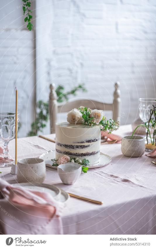 Banquet table with assorted dishware and delicious cake dessert elegant flower serve tablecloth food plate sweet celebrate pastry tasty yummy table setting