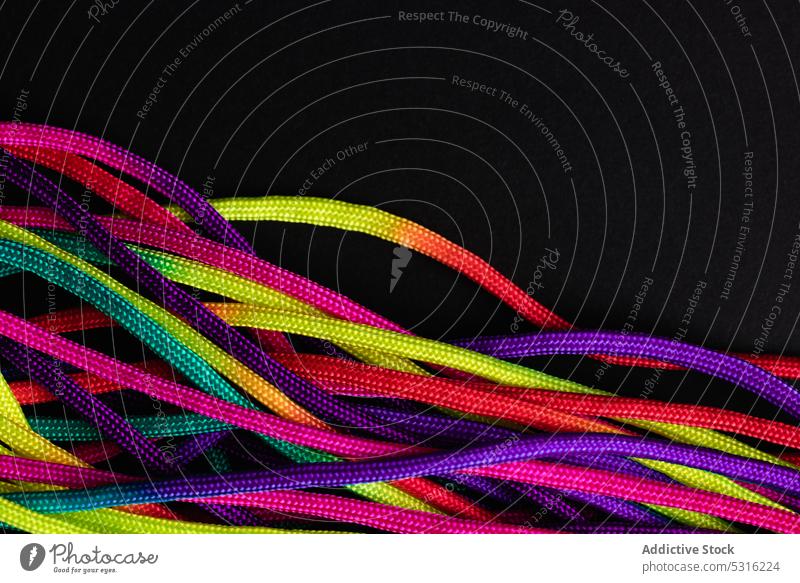 Vibrant colorful laces in pile rope twine vibrant multicolored vivid bright layout string mix shoelace cord fabric spectrum fiber untied art material minimalist