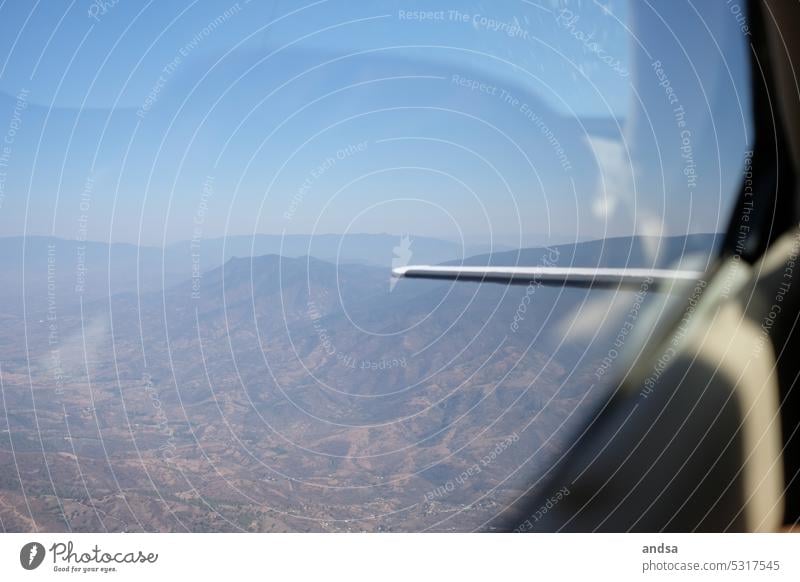 View of mountains from the plane outlook Airplane Propeller aircraft small plane Mountain Aviation Flying Bird's-eye view Vacation & Travel Sky Vantage point