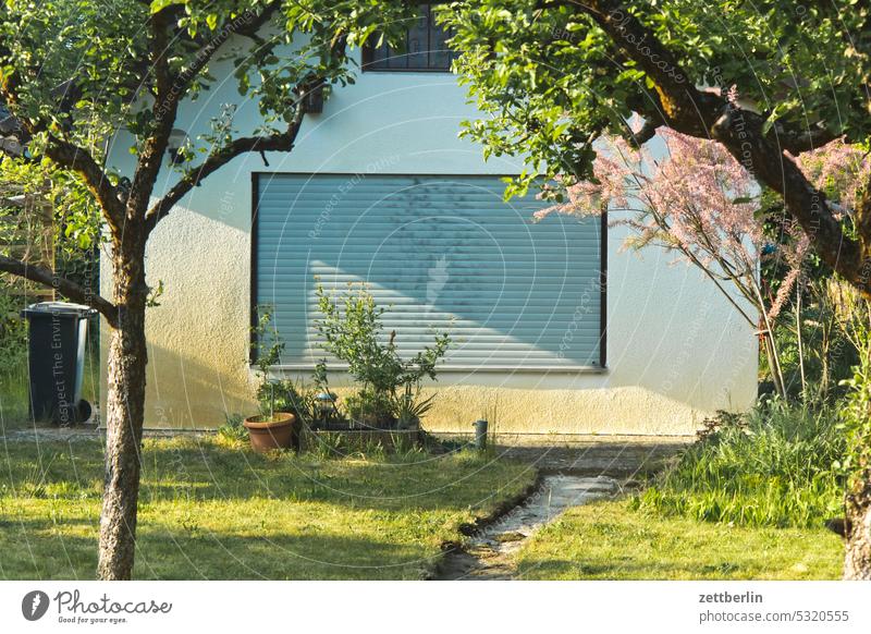 Arbor with closed blind Branch Tree blossom Blossom Dark Twilight Relaxation awakening holidays spring Spring spring awakening Garden allotment