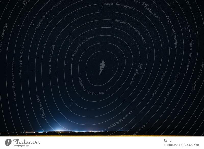 Natural Sky Background Over Rural Countryside Landscape. Night Starry Sky Above Village. Night Time color many illumination scenic glowing evening starry