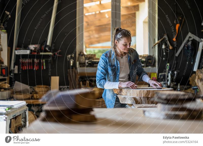 Craftswoman working with wood in a carpenter workshop real people wood workshop Carpenter Entrepreneur Competence Workshop Craftsperson Creativity Production