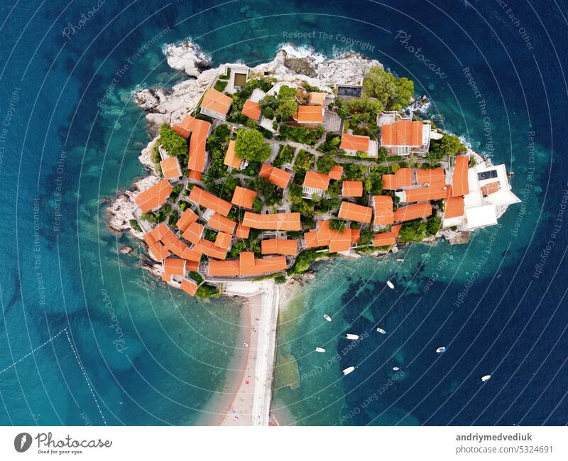 Aerophotography. Aerial view of Sveti Stefan island in a beautiful summer day, Montenegro from flying drone. Panoramic above view of Saint Stephen luxury resort. Tourism and leisure concept.