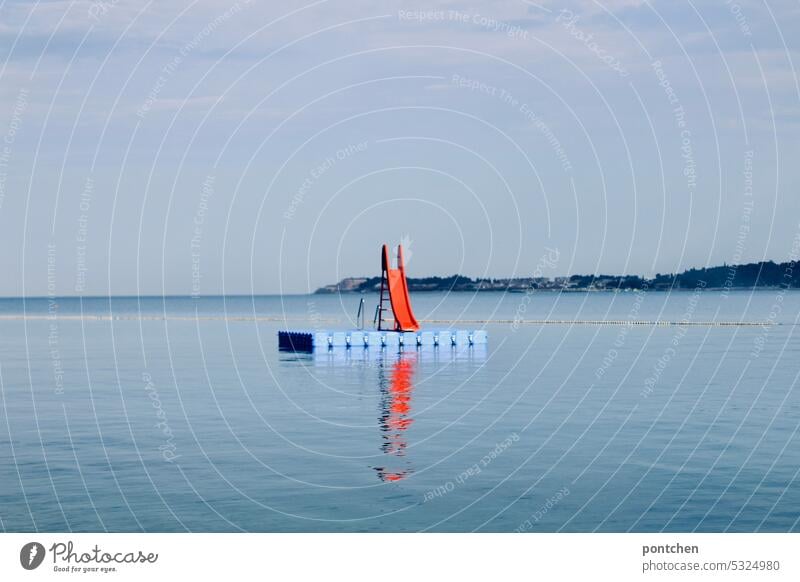 a red slide leads into the blue sea. color contrast Slide Ocean Blue bathing fun colour contrast vacation Croatia coast Adriatic Sea Vacation & Travel Landscape