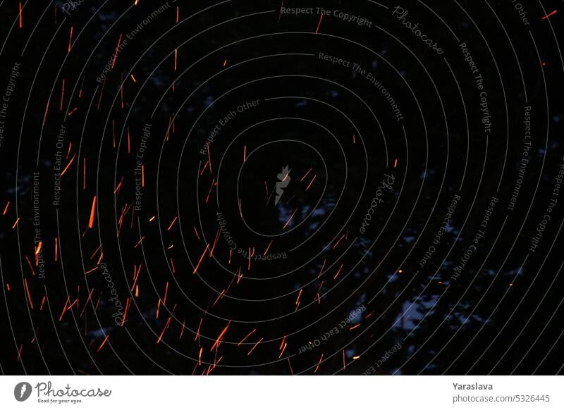 photo of sparks from a fire burning flame night abstract glowing horizontal heat no people energy motion photography campfire danger bright background
