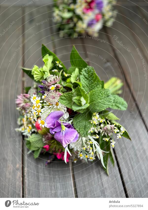 Two freshly tied bouquets of flowers lie on a wooden table Bouquet Ostrich Spring Blossom Gift Decoration flora pretty background Flower shallow depth of field