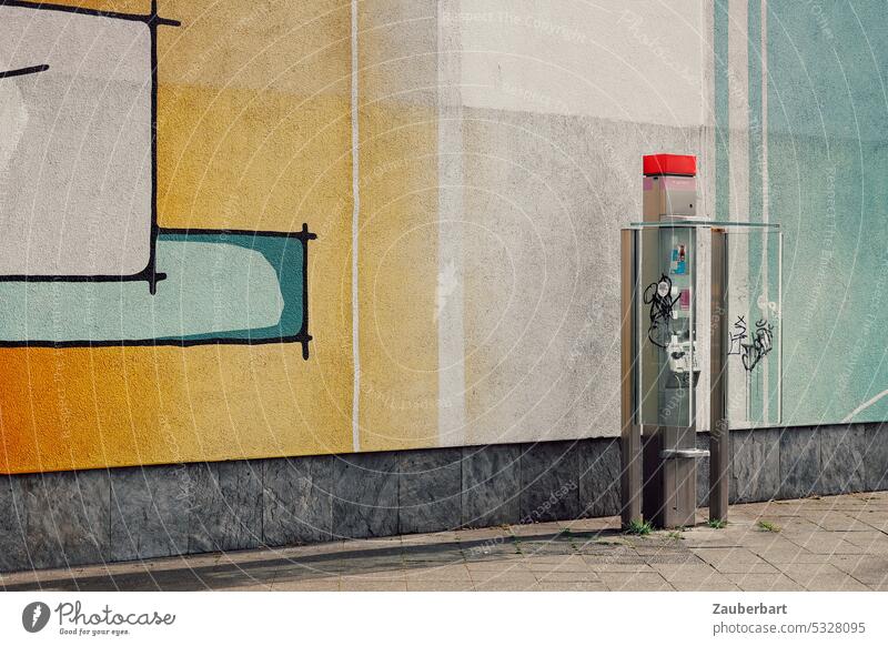 Pay phone stands lonely in front of yellow and blue striped wall Telephone Coin-operated telephone Phone box be brief make a phone call home Telecommunications