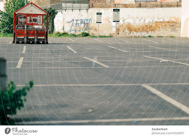 Parking lot, markings of the parking spaces, housing for shopping carts of a supermarket Shopping Trolley Supermarket Red White Gray Empty bleak SHOPPING