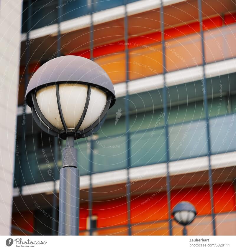 Street lamp in front of red and gray rectangular facade streetlamp Lantern Street lighting 1970s '60s Modern Red Gray Architecture urban bleak Banal colored