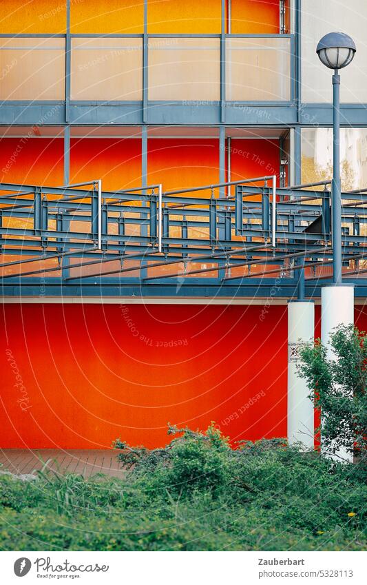 Street lamp in front of red and gray rectangular facade streetlamp Lantern Street lighting 1970s '60s Modern Red Gray Architecture urban bleak Banal colored