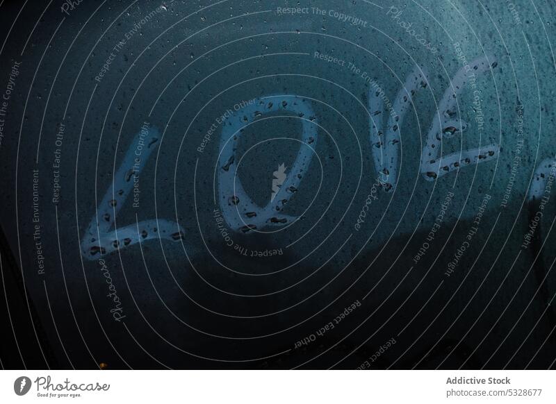 Love title and symbol of heart on car window love inscription fogging up automobile rainy weather vehicle happy romantic travel drive trip fun happiness