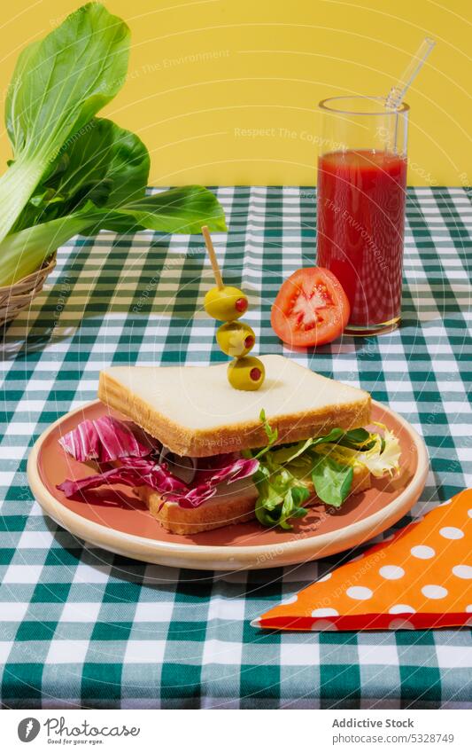 Delicious smoothie and healthy sandwich on checkered tablecloth salad tomato juice lettuce healthy food refreshment drink breakfast lunch eco friendly