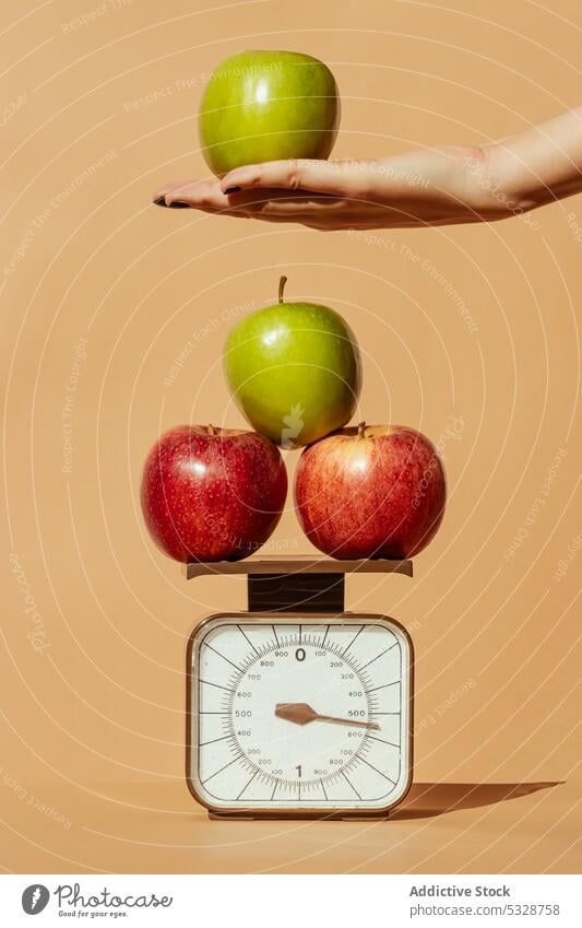 Crop woman weighing fresh apples on scale hand weight concept fruit diet healthy balance healthy food vitamin female healthy lifestyle stack green red organic