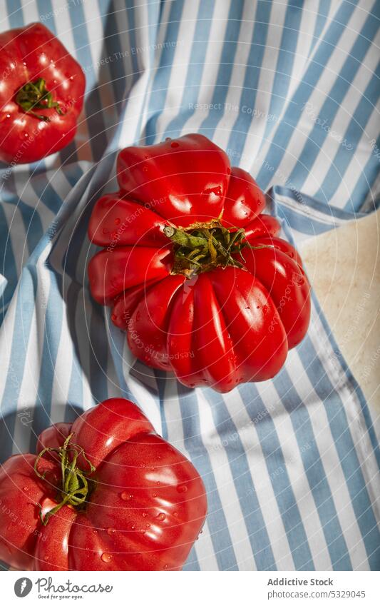 Ripe tomatoes on tablecloth over plane surface red fresh checkered ripe healthy tasty vegetable organic ingredient natural vitamin food nutrition vegetarian raw