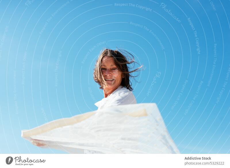 Woman extended arms against blue sky woman spin around outstretch cloak stroll vacation summer nature female holiday enjoy travel freedom tourism alone leisure