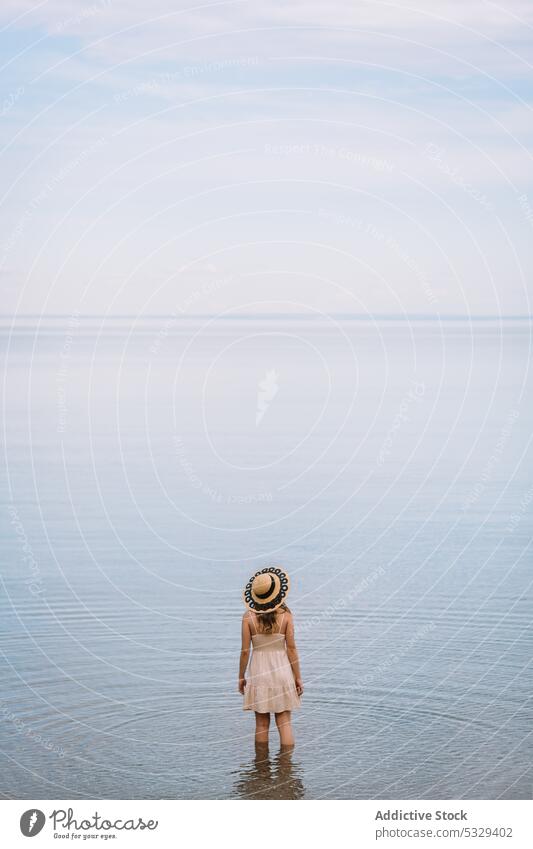 Woman in sunhat admiring seascape woman tourist admire ocean shore relax chill cloudy female model travel trip journey explore summer vacation weekend nature