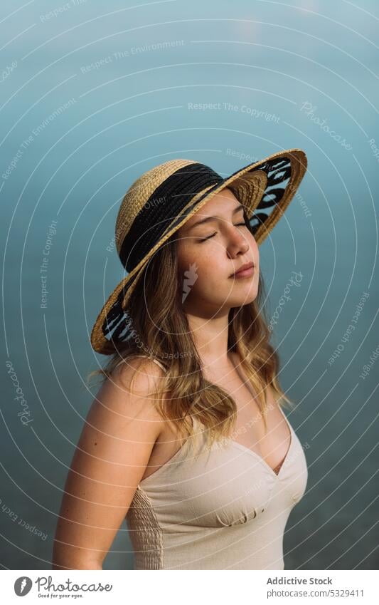 Woman in sunhat chilling in gloomy weather woman tourist sunbath summer weekend straw hat cloudy female model travel trip journey vacation holiday nature coast