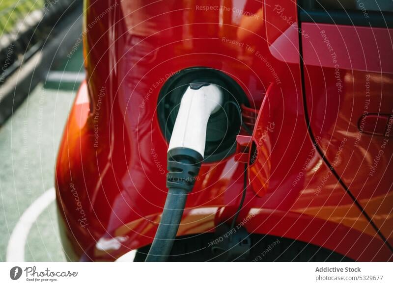 Modern car parked on charging station charge automobile power battery transport renewal alternative electric asphalt energy modern contemporary eco friendly