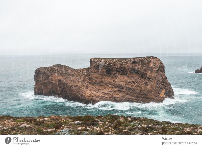 Rocky coastline of the Atlantic Ocean in the south-west of Portugal in the Algarve region. Exploring the beautiful rugged nature of the Fisherman Trail. Cape St. Vincent